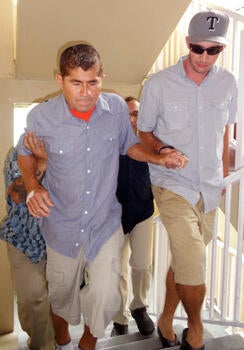 Pacific castaway Jose Salvador Alvarenga (L) is helped into a press conference in the Marshall Islands