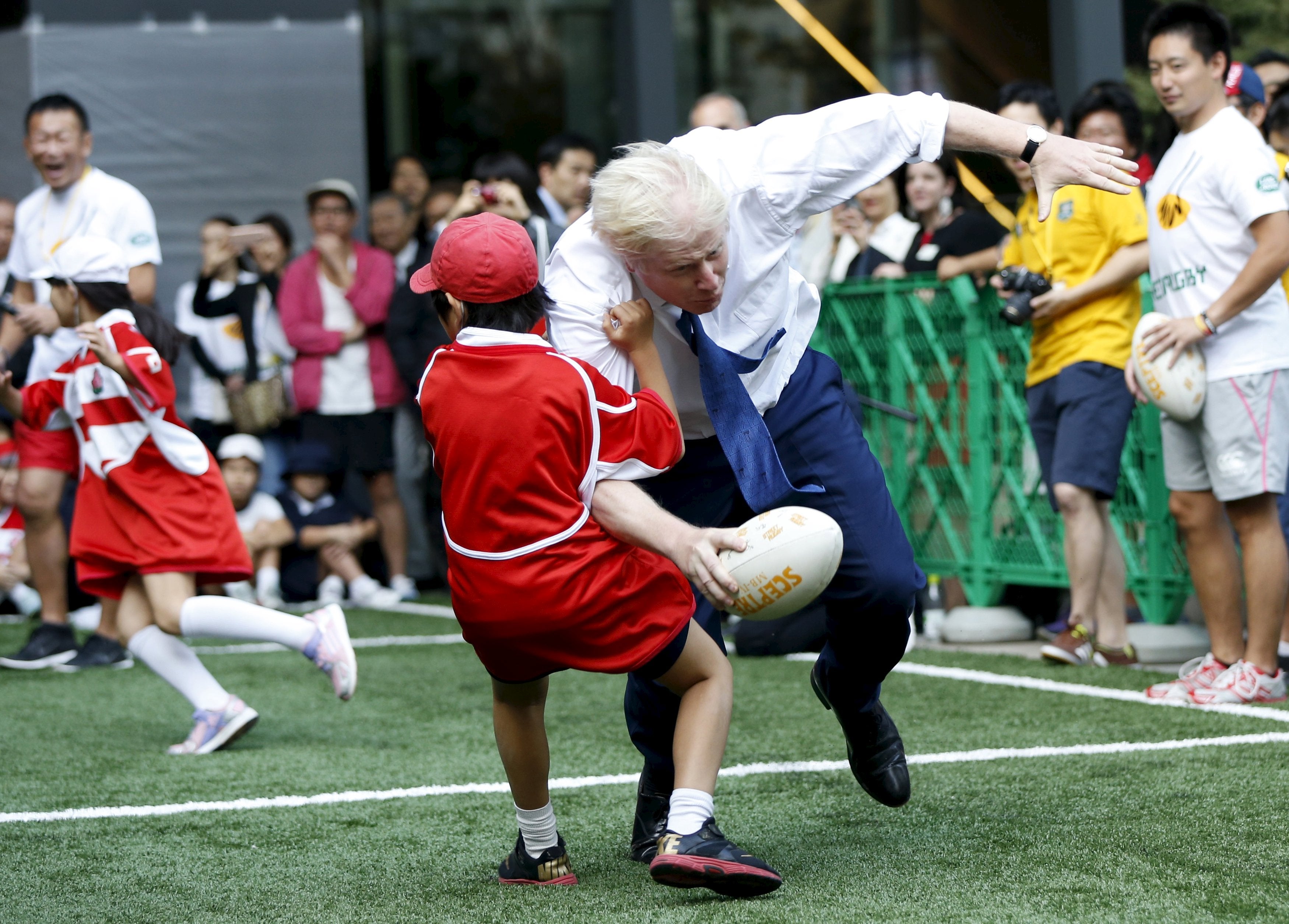 London Mayor Boris Johnson topples 10yearold in rugby game CBS News