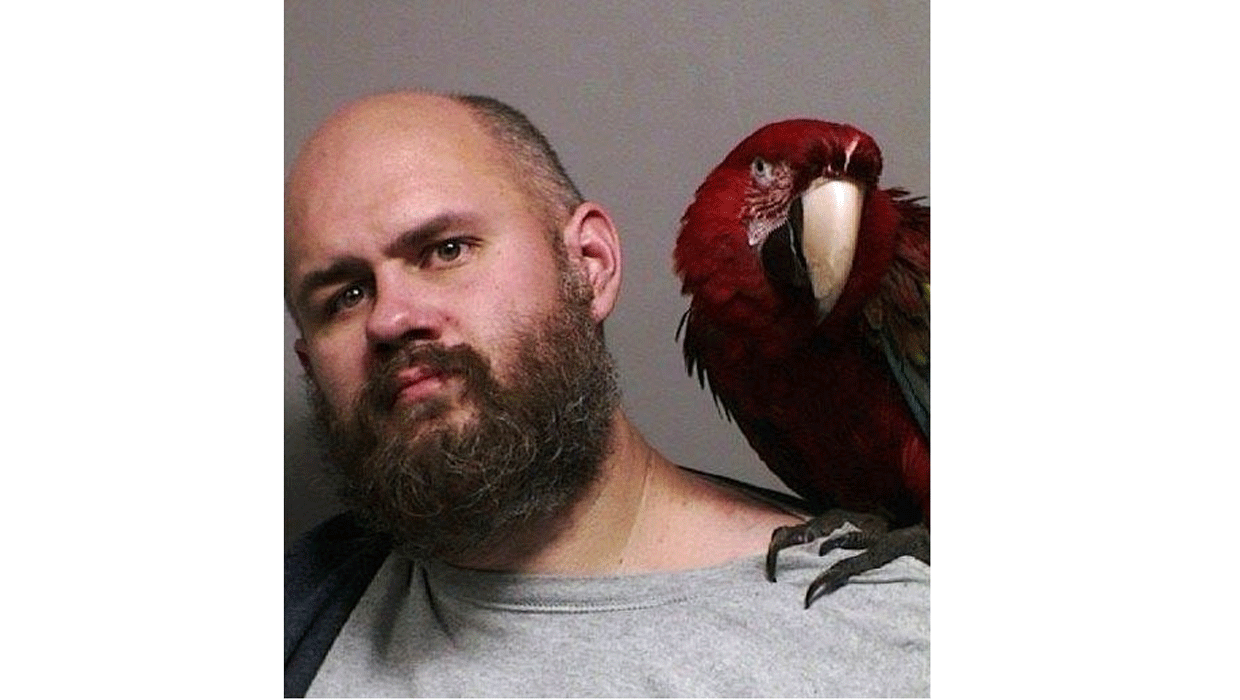 Craig Buckner poses with pet macaw, "Bird," in Oregon mugshot CBS News