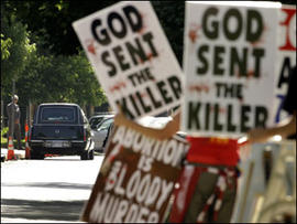 Protesters from Rev. Fred Phelps' Westboro Baptist Church demonstrate during funeral services for Dr. George Tiller Saturday, June 6, 2009, at College Hill United Methodist Church in Wichita, Kan.
