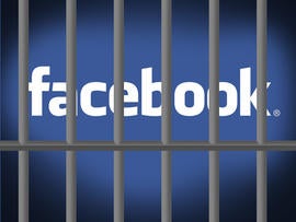 Facebook logo behind prison bars