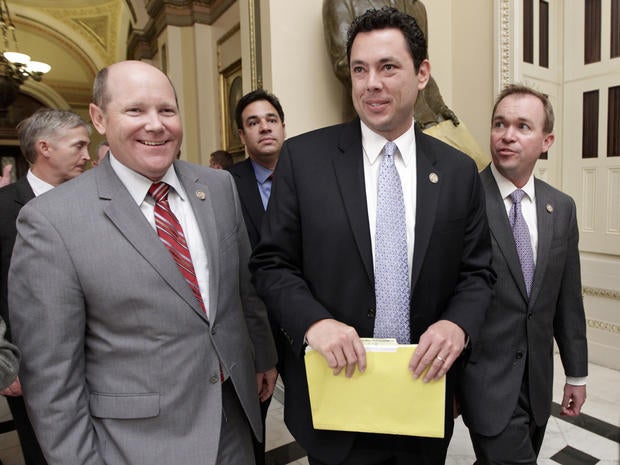 Rep. Reid Ribble, R-Wis., left, Rep. Jason Chaffetz, R-Utah, center, and other House Republicans, smile after passage of a conservative deficit reduction plan
