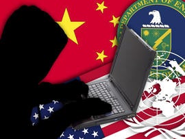 Hacker in the front of a laptop computer