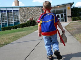 Schoolboy walking up to school