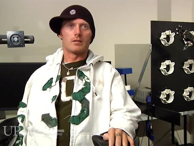 Robotic arm lets paralyzed man touch girlfriend