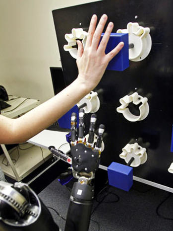 Robotic arm lets paralyzed man touch girlfriend