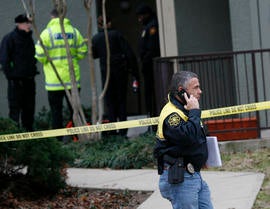 Grapevine police investigate the scene where they found seven people dead outside Dallas in Grapevine, Texas, Sunday, Dec. 25, 2011. Four women and three men who police believe to be related were found apparently shot to death, and authorities said they believe the shooter is among the dead.