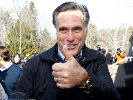 Former Massachusetts Gov. Mitt Romney gives a thumbs up as he campaigns on primary day outside a polling station at Webster School in Manchester, N.H., Jan. 10, 2012.