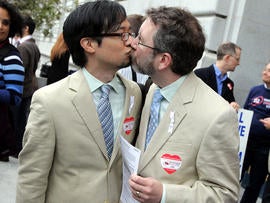 Same-sex couple Jeff Tabaco, left, and Thom Watson kiss as they hold paperwork for a marriage license Aug. 12, 2010, in San Francisco.