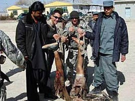 Soldiers from the Army's 82nd Airborne Division pose with the mangled corpose of a suicide bomber in Afghanistan's Zabol province. The image was first published in the LA Times, which received it from an unnamed soldier in the division.In this image provided to the LA Times by a soldier in the division.