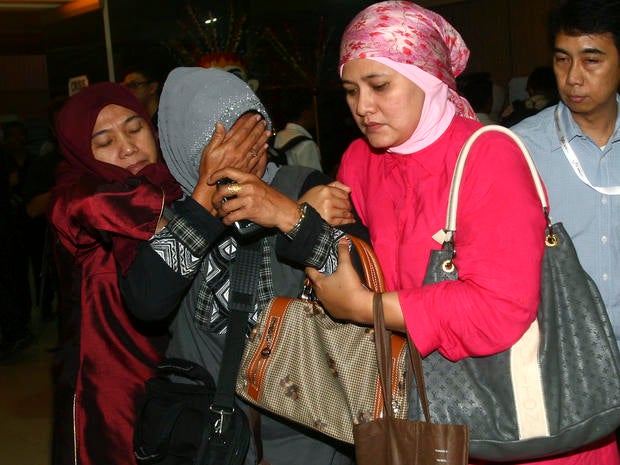 A relative weeps after inspecting the list of passengers reportedly on board a missing Russian airplane at Halim Perdanakusuma Airport in Jakarta, Indonesia, May 9, 2012.