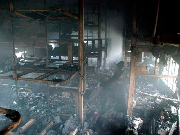 A totally charred coach from inside is seen of a passenger train