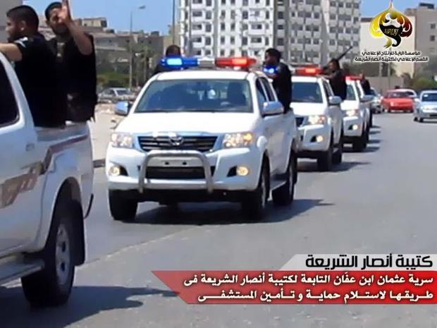 Militants from the Libyan Ansar al-Sharia group drive through Benghazi