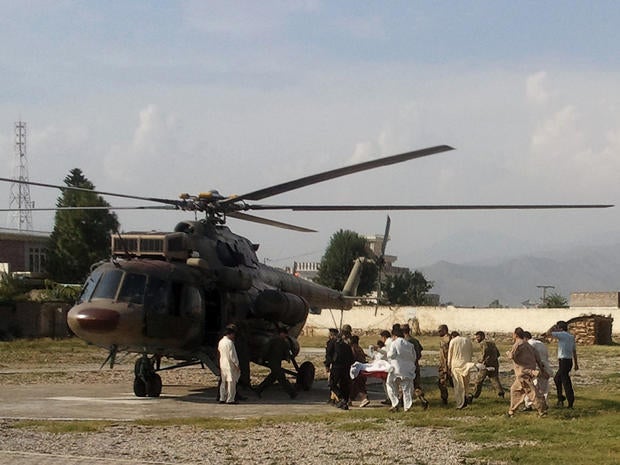 A wounded Pakistani girl, Malala Yousufzai, is moved to a helicopter.
