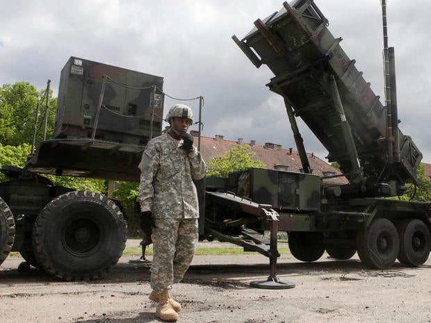 A U.S. soldier stands next to a Patriot surface-to-air missile battery