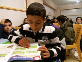 Omar, 13, attends a makeshift school in Turkey with 500 other children who have fled Syria's civil war.