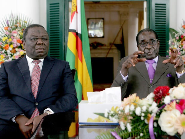 Zimbabwe's President Robert Mugabe (R) and Prime Minister Morgan Tsvangirai (L) announce the conclusion of the constitution making process at State House.