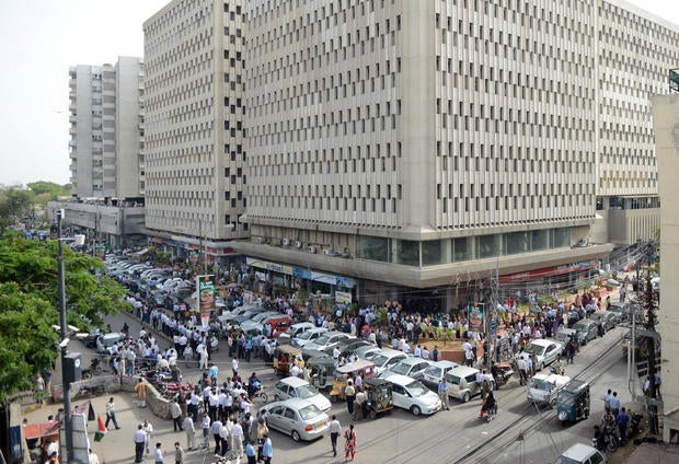 Pakistanis evacuated from buildings in Karachi following a massive earthquake centered in neighboring Iran