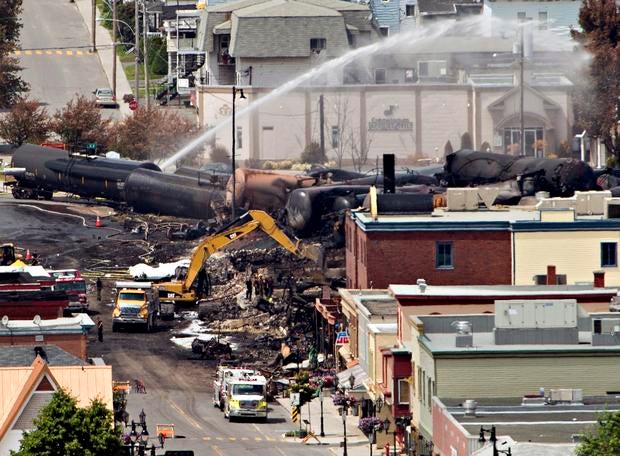 Searchers dig through the rubble for victims of a train derailment in Lac-Megantic, Quebec