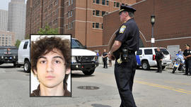 A U.S. Marshal's van, believed to be carrying Boston Marathon bombing suspect Dzhokhar Tsarnaev, arrives at the federal courthouse for his arraignment Wednesday, July 10, 2013, in Boston.