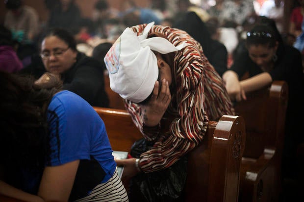 An Egyptian Coptic Christian woman prays in a church within Al-Mahraq Monastery in Assiut, Upper Egypt.