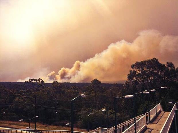 Smoke rises from a fire near Springwood, west of Sydney, Australia
