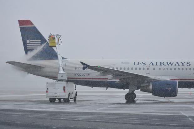 A worker at Lehigh Valley International Airport works on deicing and anti-icing an aircraft