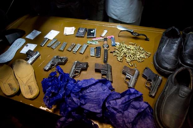 Afghanistan's intelligence service displays some of the weapons and belongings of attackers on the Serena hotel, during a press conference at the Interior ministry in Kabul