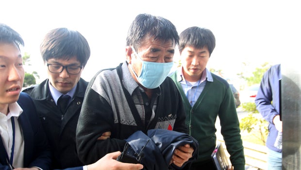Lee Joon-seok (2nd R), captain of the sunken South Korean ferry Sewol, arrives at the headquarters of a joint investigation team of prosecutors and police in Mokpo
