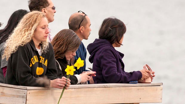 People gather on the beach for a vigil in honor of slain student Maren Sanchez in Milford, Connecticut, April 25, 2014.