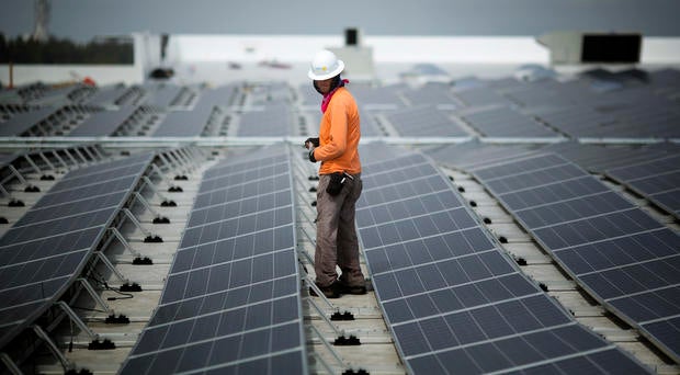 Neil Black works on the installation of South Florida's largest solar 