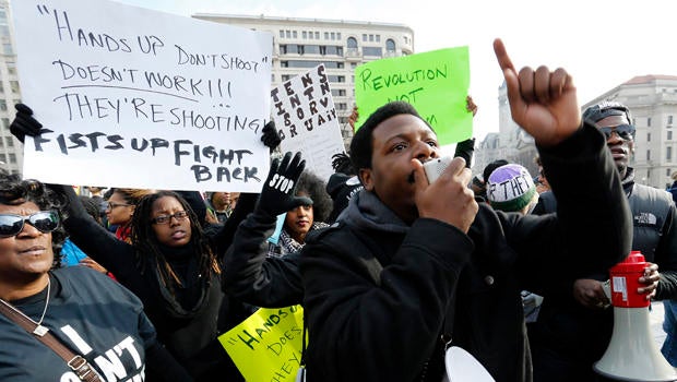Demonstrators rally before the national Justice For All march against police violence in Washington Dec. 13, 2014.
