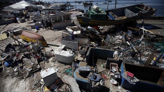 Several coastal towns were flooded from small tsunami waves set off by late Wednesday's quake, which shook the Earth so strongly that rumbles were felt across South America. AP PHOTO/LUIS HIDALGO