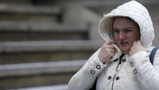 A woman bundles up during the morning commute on Wall Street in lower Manhattan in New York Jan. 19, 2016.