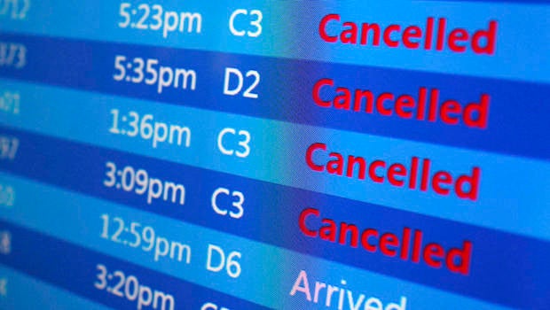Canceled flights are displayed on a status board at New York's Laguardia Airport ahead of a powerful winter storm Jan. 22, 2016.