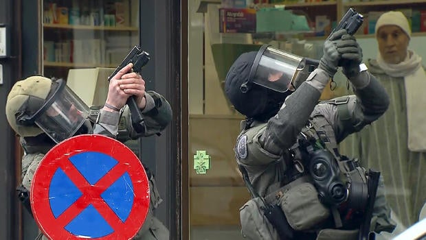 Armed Belgian police secure the area in this still image taken from video upon their arrival in the Molenbeek neighborhood of Brussels, Belgium, March 18, 2016.