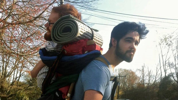 A friend carries Kevan Chandler on his back.