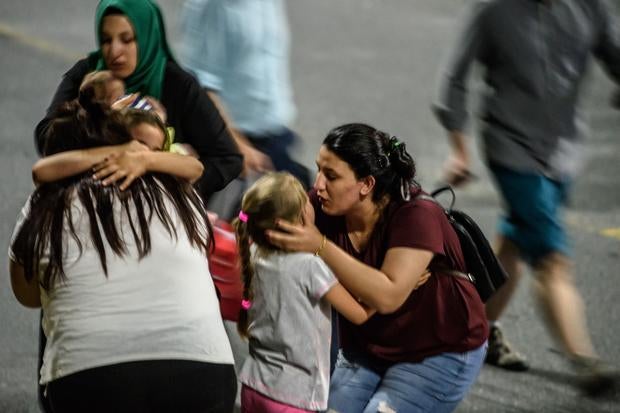 Relatives embrace as they leave Istanbul's Ataturk Airport after June 28, 2016 assault that took dozens of lives and wounded dozens more