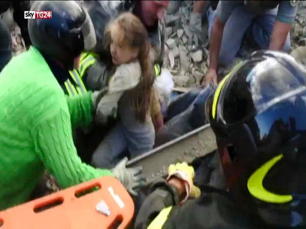 In this image taken from a video, a 10-year-old girl is pulled alive from the rubble following an earthquake in Pescara Del Tronto, Italy