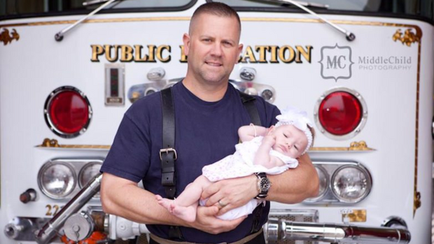 Marc Hadden poses with his newborn daughter, Gracie, shortly after her adoption.
