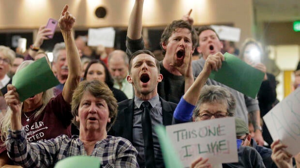 People shout to Rep. Jason Chaffetz during his town hall meeting at Brighton High School Feb. 9, 2017, in Cottonwood Heights, Utah.