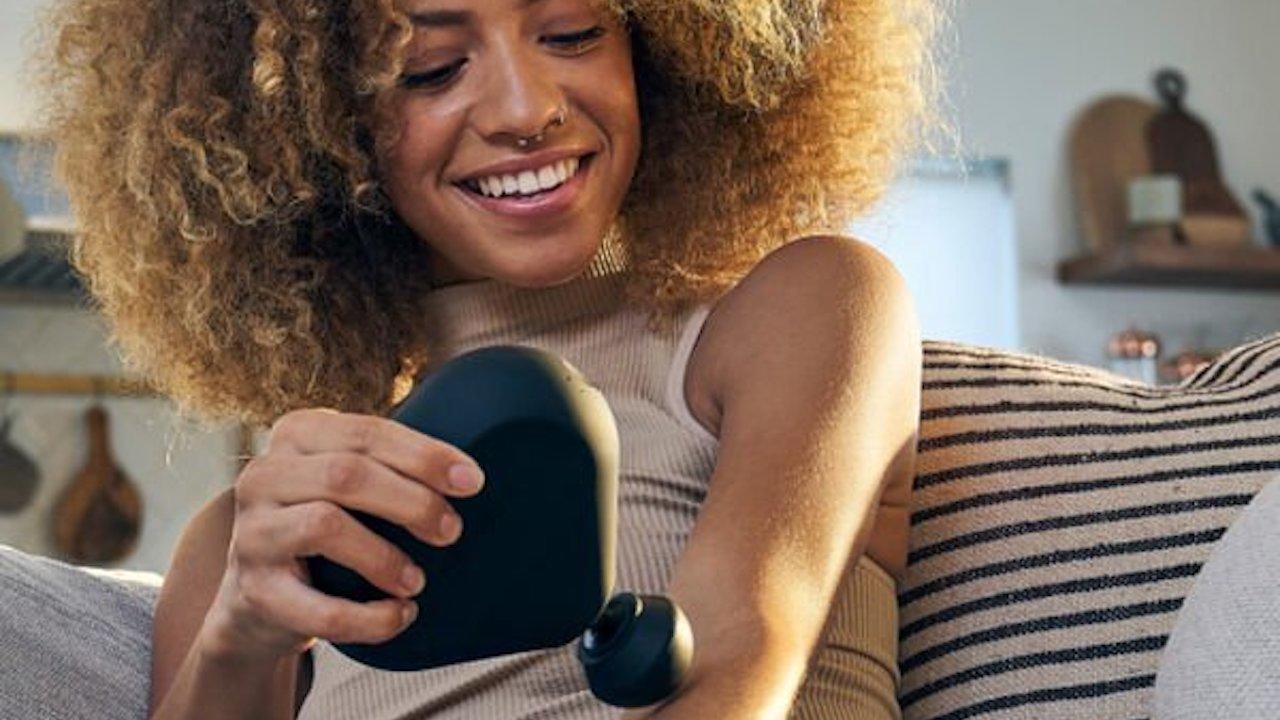 woman using handheld massager 