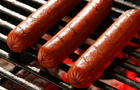  Hot dogs on a grill. 