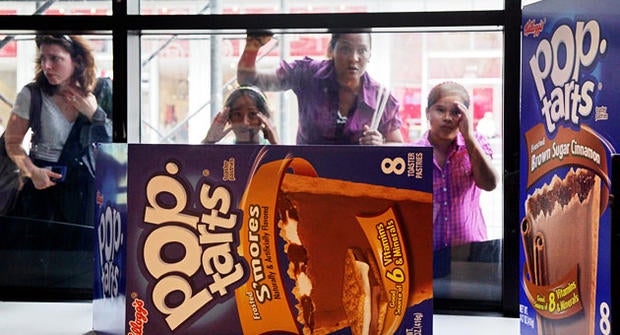 People peer in the window of the Pop-Tarts World store, Monday, Aug. 9, 2010, in New York's Times Square.