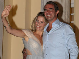 Prince Nikolaos of Greece and his fiancee, Tatiana Blatnik, wave from the steps of the Poseidon Hotel as they attend their pre-wedding reception on Aug. 24, 2010, in Spetses, Greece. (Getty Images)