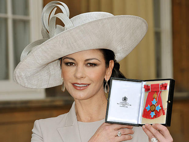 Catherine Zeta-Jones holds herCommander of the Order of the British Empire (CBE) at Buckingham Palace in London, on Feb. 24, 2011. (STILLWELL/AFP/Getty Images)