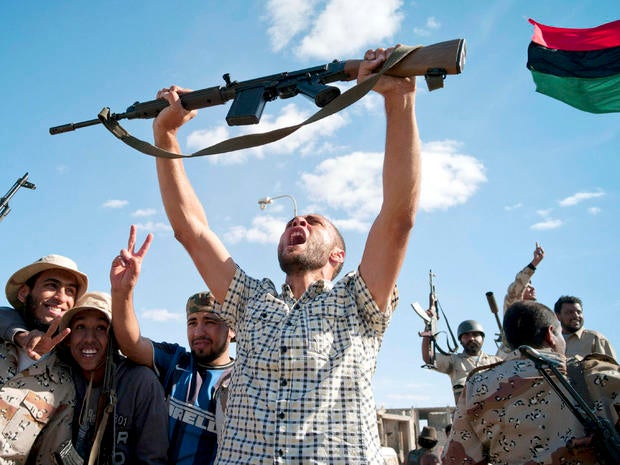Libyan revolutionary fighters celebrate in Muammar Qaddafi's hometown of Sirte Oct. 20, 2011.