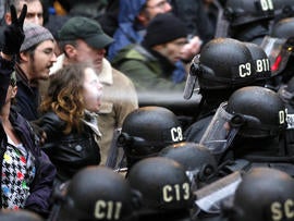 A police officer uses pepper spray on an Occupy Portland protester at Pioneer Courthouse Square in Portland, Ore., Nov. 17, 2011.