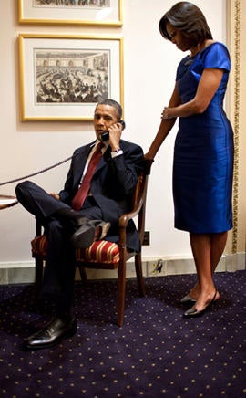 President Obama, accompanied by first lady Michelle Obama, is seen on a phone call at the Capitol in Washington Jan. 24, 2012, immediately after his State of the Union address, informing John Buchanan that his daughter Jessica was rescued by U.S. special operations forces in Somalia.