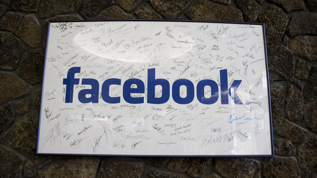 A framed Facebook logo, filled with employees' signatures, hangs in the lobby of the company's Palo Alto, Calif., building in June 2009. 